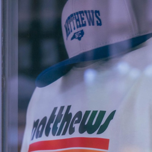 A place to call home a mannequin in a window with a shirt and hat