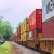 a railroad with a train carrying cargo
