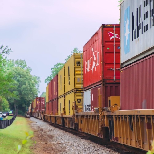 Close to the center of everything a railroad with a train carrying cargo