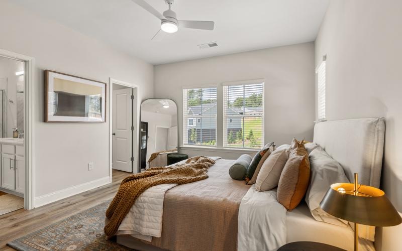 a bedroom with a bed and a fan