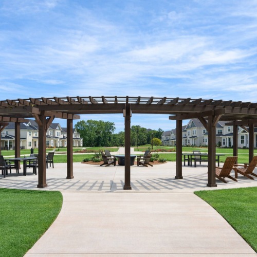large, pergola covered patio with tables and chairs