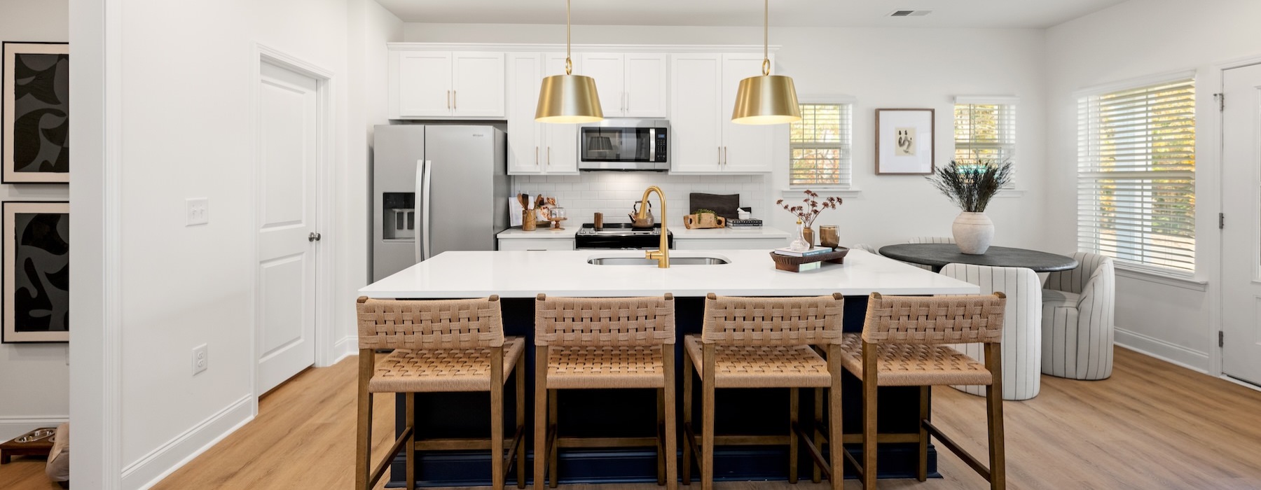 a kitchen with an island and chairs